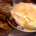 "Cooper" $7.77 A skillet of seasoned redskin potatoes, onion, green peppers, bacon, turkey and cheddar cheese topped with three over-easy eggs and hollandaise and served with your choice of toast.